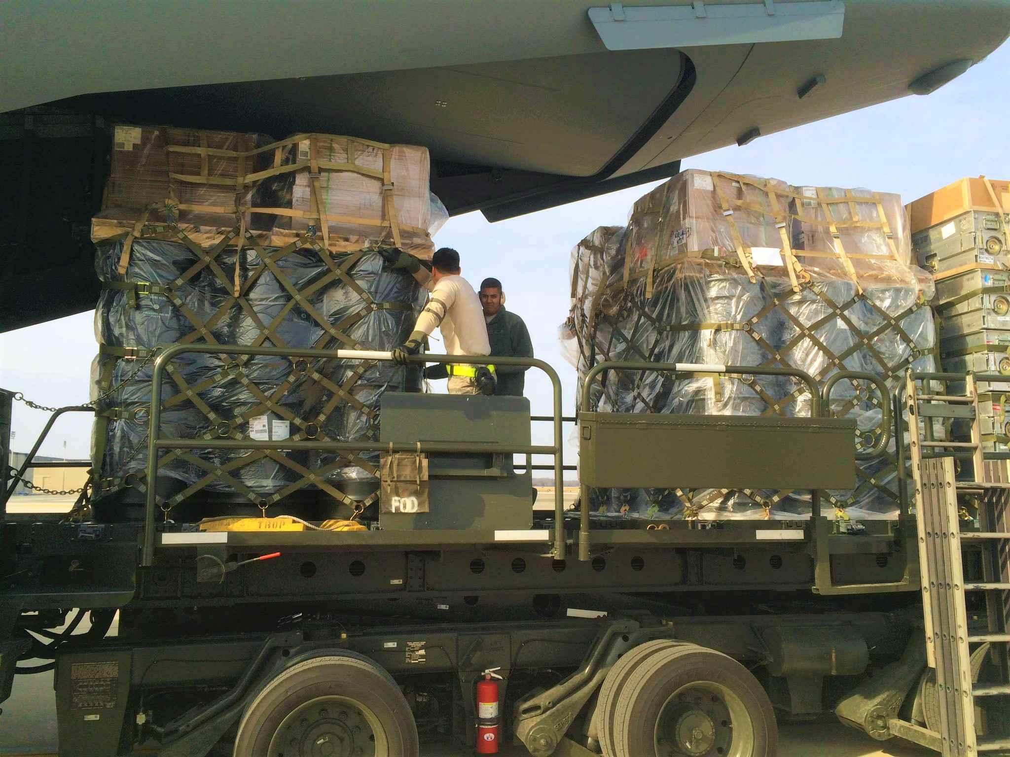 Military freight being loaded onto a plane