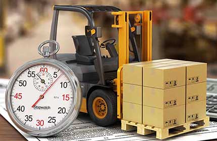 Toy forklift and golden coins in front of a clock
