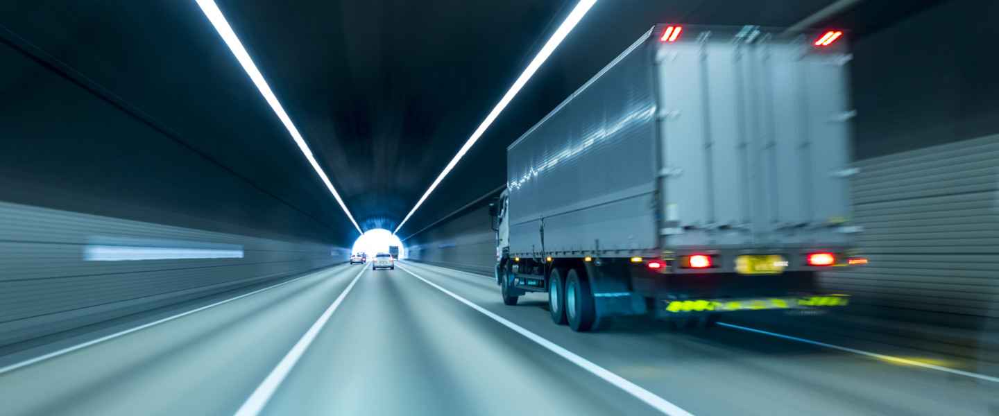 Trailer truck speeding through a tunnel