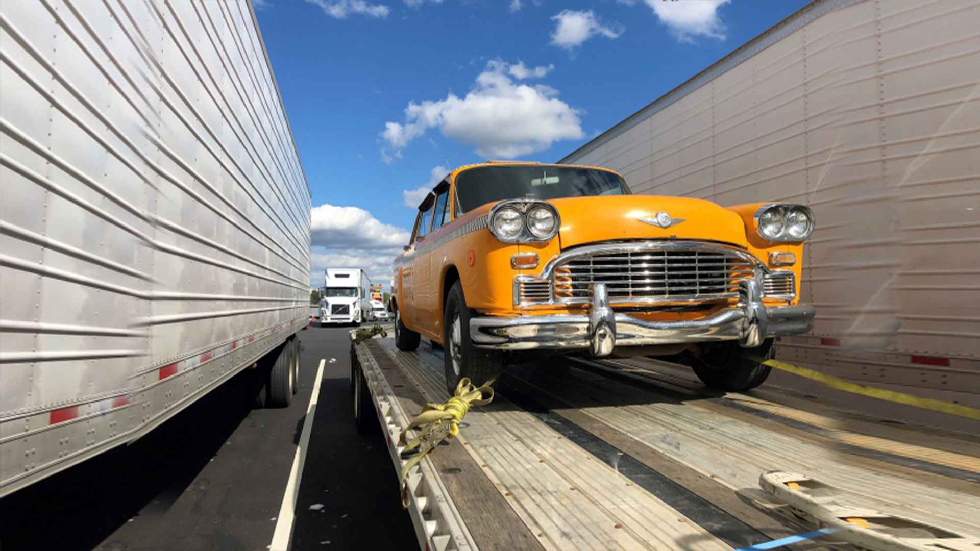 Classic yellow cab tied to trailer